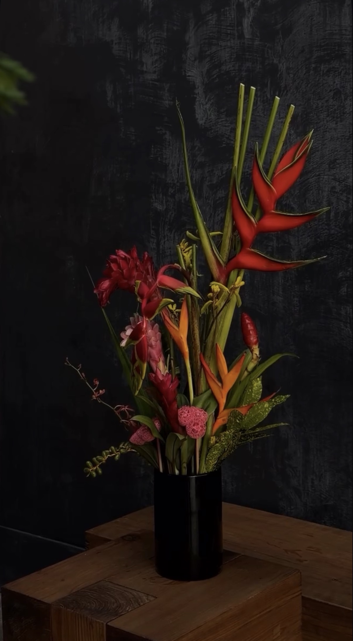 Tropical floral arrangement with red heliconia