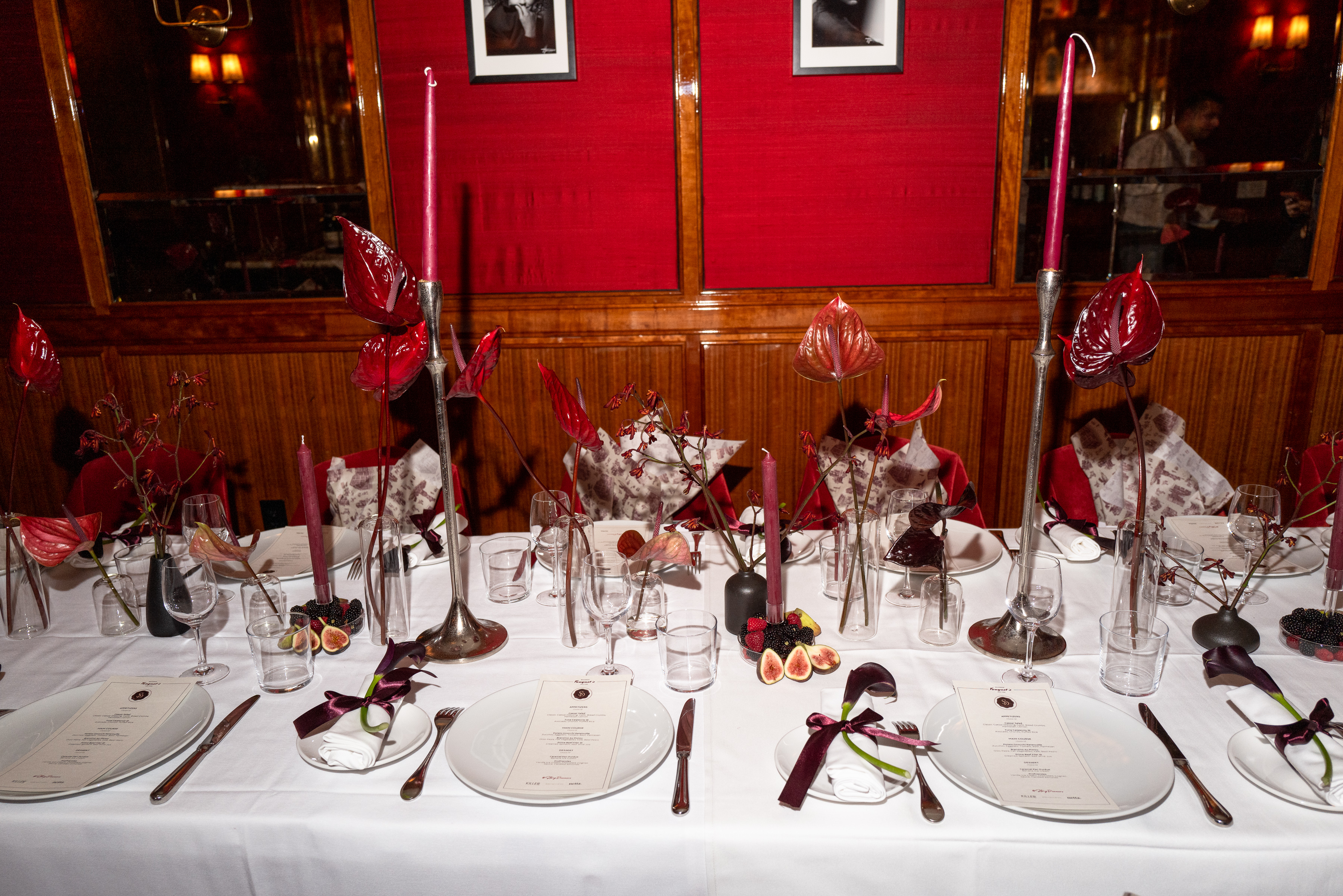 Story dinner tablescape with red anthurium and candles
